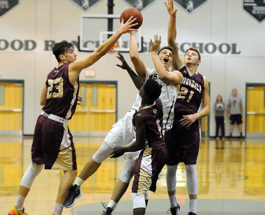 Lakewood Ranch sophomore forward Jack Kelley muscles his way to the hoop.
