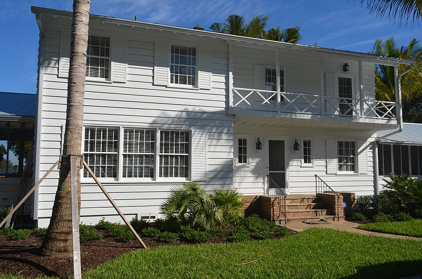 The home features a main house and two wings connected by enclosed breezeways.