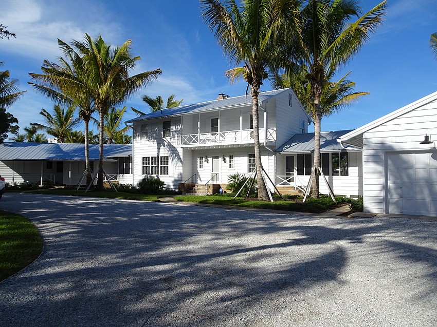 The home features a main house and two wings connected by enclosed breezeways.
