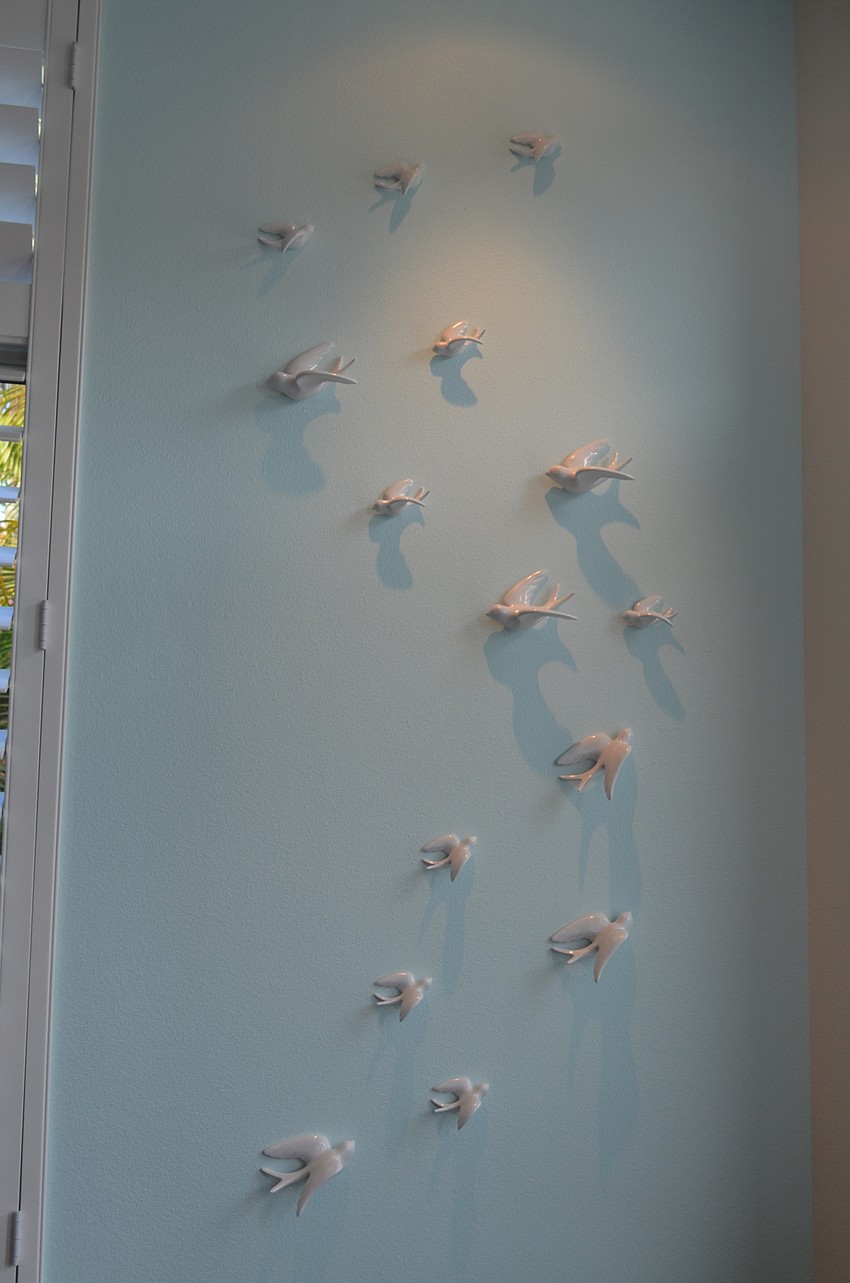 The display of birds captured in movement is featured in the master bedroom.