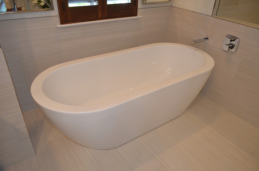 A fixture of the master bathroom is a freestanding bathtub.