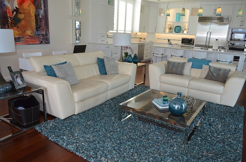 The living room features the color blue, a trend throughout the house.