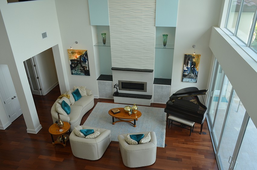 The home’s great room features an open space with two stories of windows.