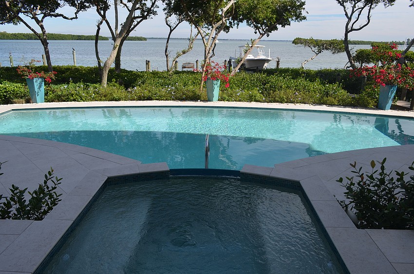 The home’s pool and spa area provide views of the bay.