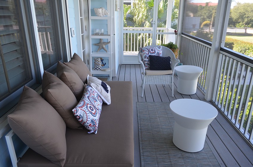The screened-in patio on the main level provides a view of the landscaping and surrounding homes.
