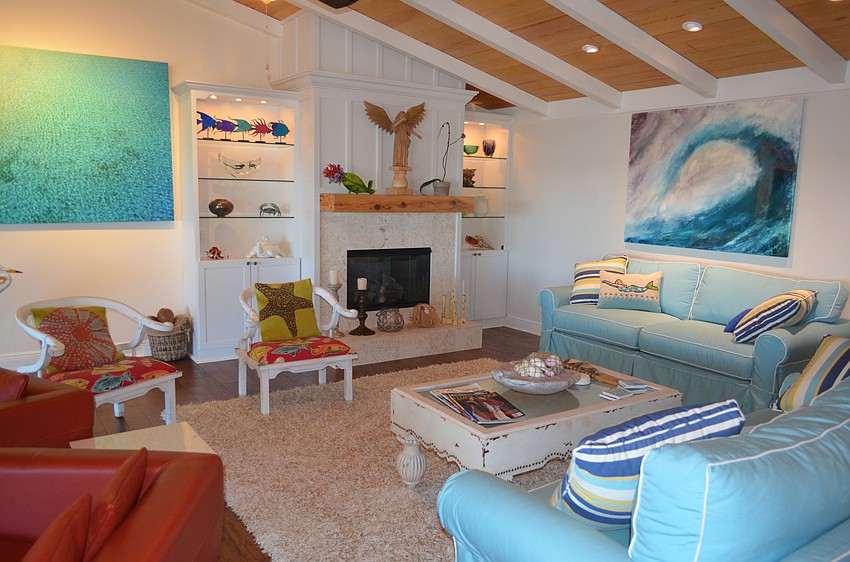The living room features many unique furniture and pieces of art, many with an ocean theme.