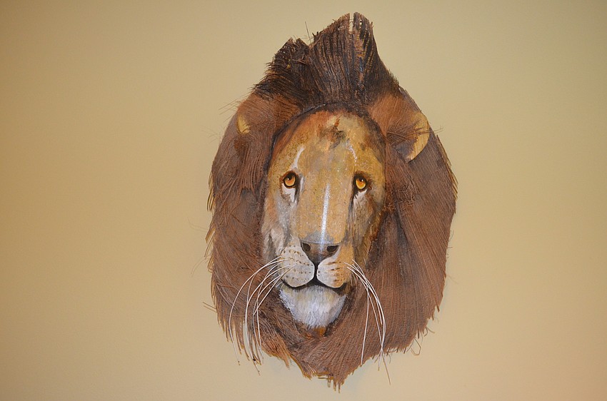 Above the bed in the guest bedroom are exotic animals handcrafted from Florida palm fronds.