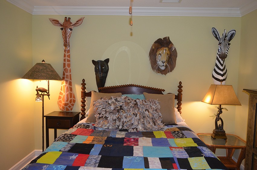 Above the bed in the guest bedroom are exotic animals handcrafted from Florida palm fronds.