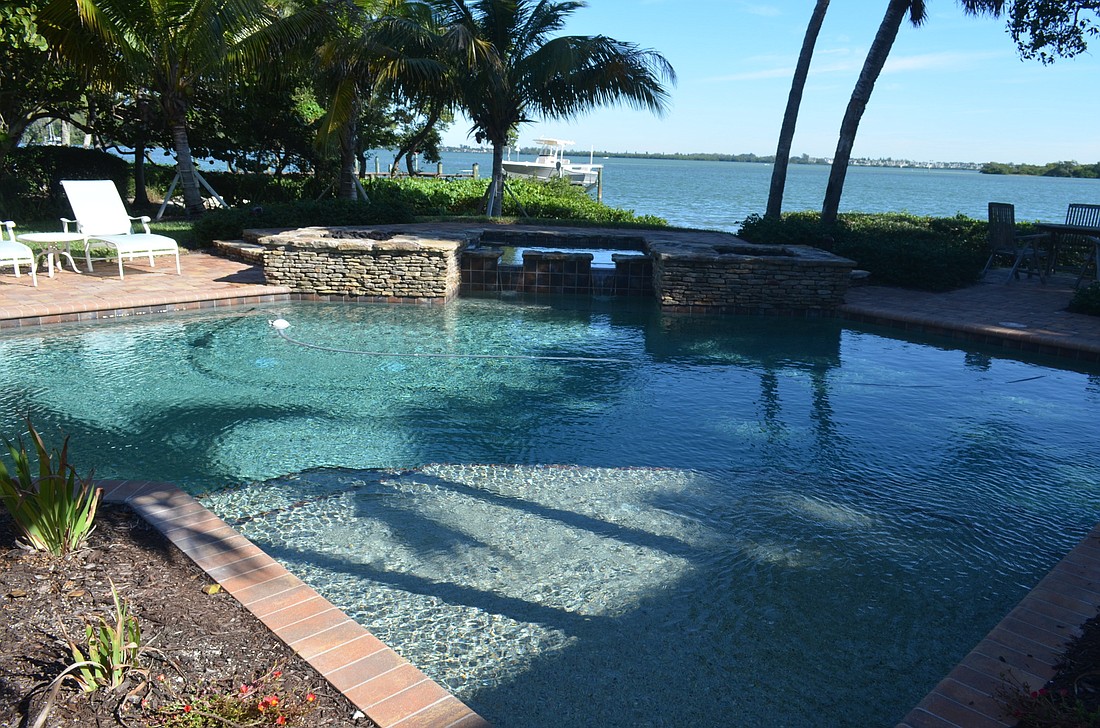 Your Observer Photo The backyard area includes a pool, hot tub and