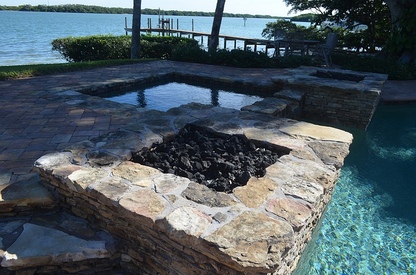 Two fire pits surround the hot tub.