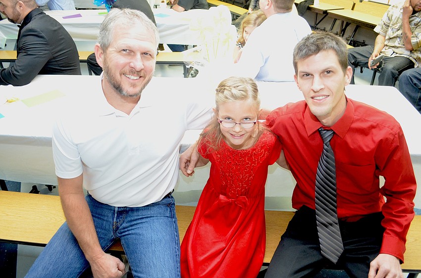 Jaylynn Garber (center) has two dates to the dance, her grandfather, Tom, and her father, Nathan.