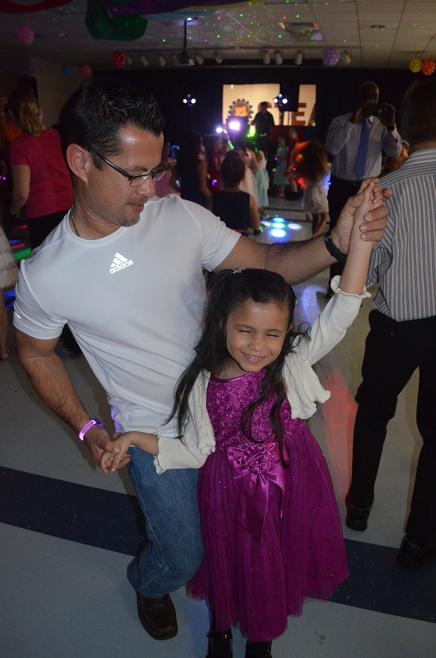 Leo Solorzano spins his daughter, Leuska, on the dance floor.