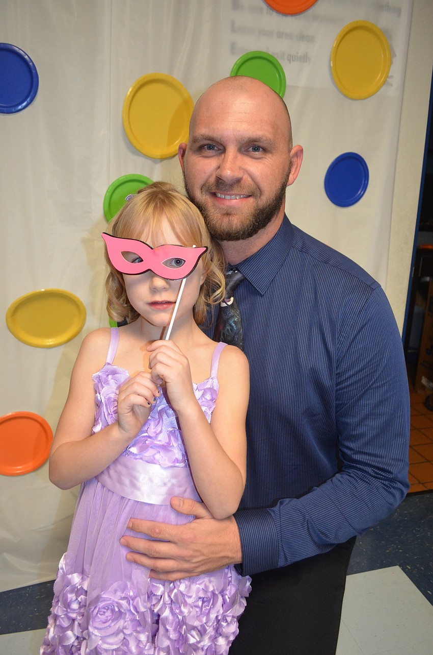 Sarah Lawson and her father, Nathan, find props and the photo booth.