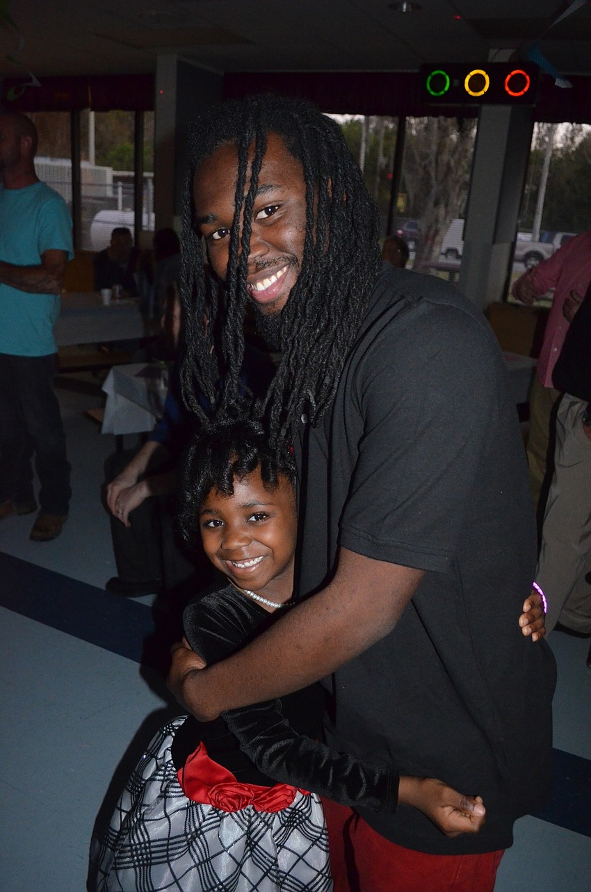 Serenity Jessie and her father, Deon, dance before getting snacks and drinks.