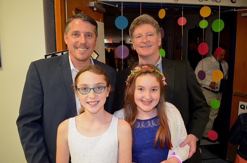 Randy Kuiken and Chris Brugger escort their daughters, Sydney Brugger and Brooke Kuiken, to the dance.