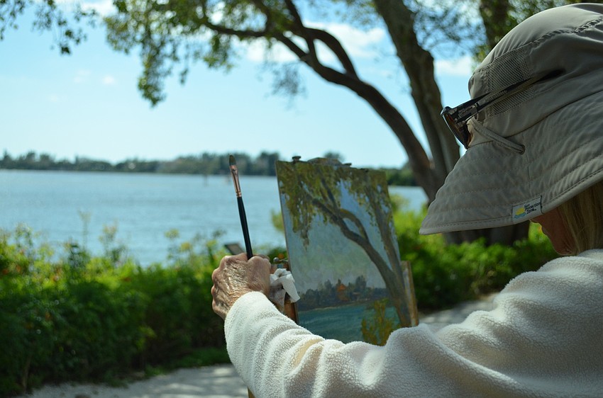 Coleen Kordas uses the twisted branches near the White Cottage as inspiration at Historic Spanish Point.