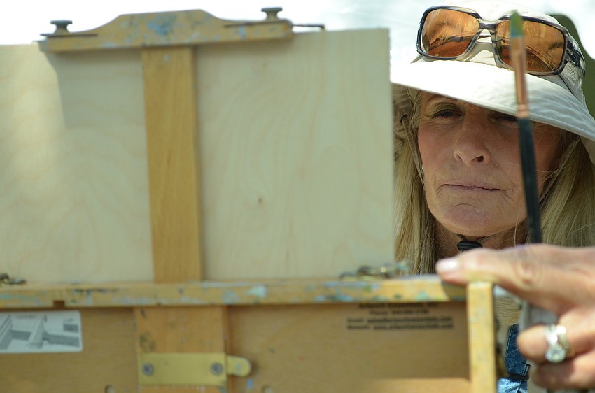 Coleen Kordas focuses on finishing her piece.