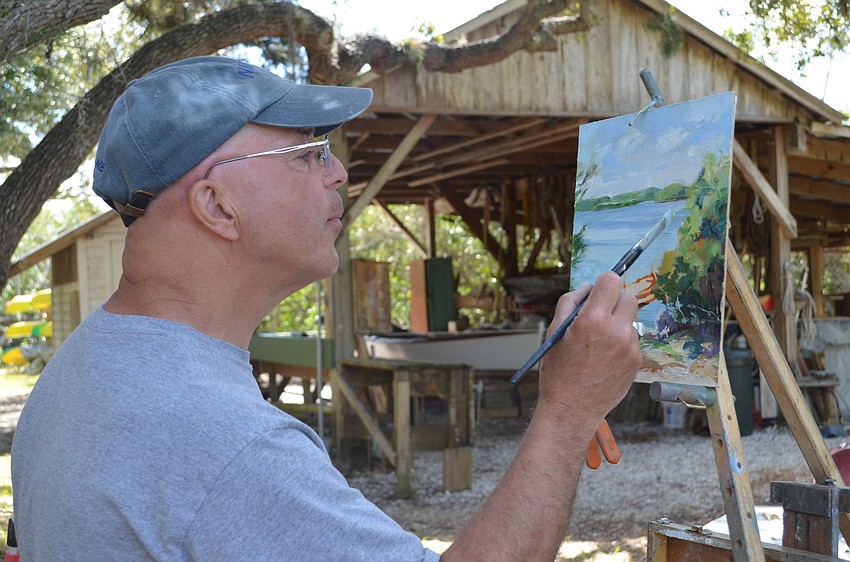 John Caggian puts the finishing touches on his piece.