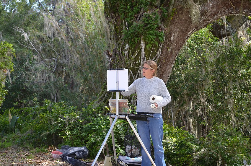 Kelli Mason stands surrounded by the greenery at Historic Spanish Point during an event for Paint Sarasota Paint Out.