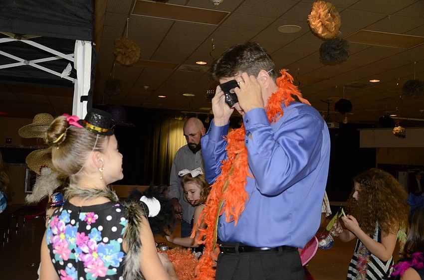 Delaney and Tom Kundrat get prepped for the photo booth.