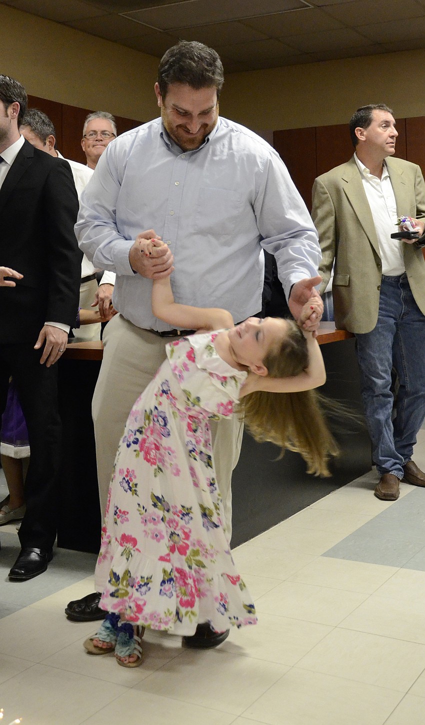 Josh and Grace Hoot dance while waiting in line. 