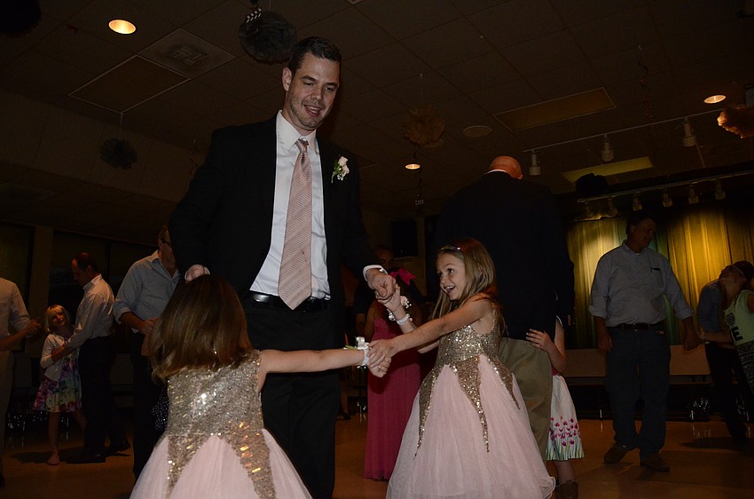 Jay Mulligan dances with his two daughters, Kylie and Julia, during the first dance.