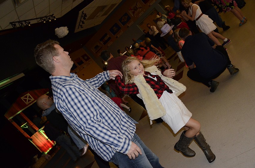 Brett and Aspen Strot dance along to a song.