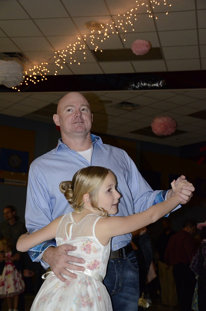 Matt and Sophia Eastman sway to a slow song.
