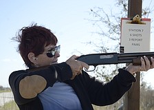 Kiwanis member Barbara Anson takes aim.