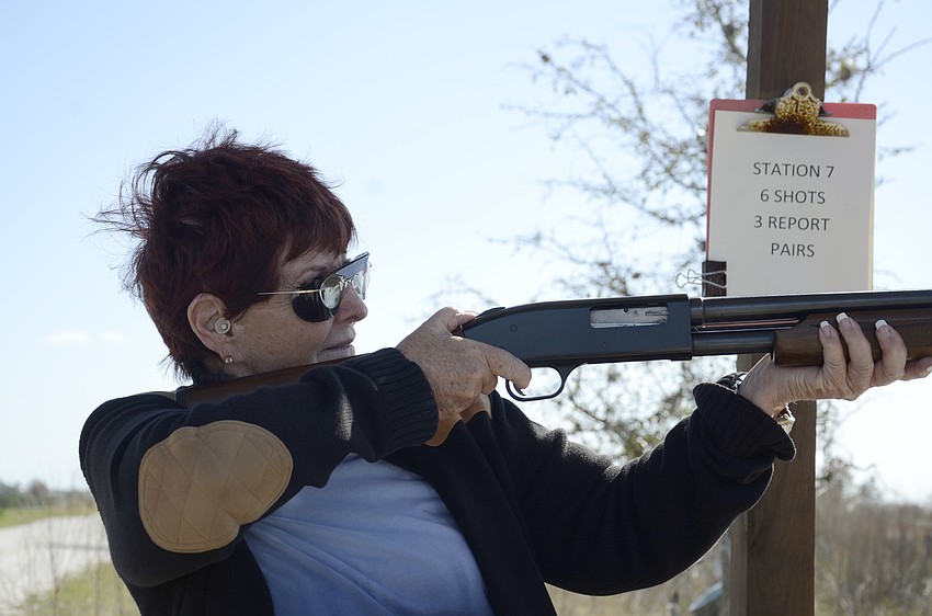 Kiwanis member Barbara Anson takes aim.