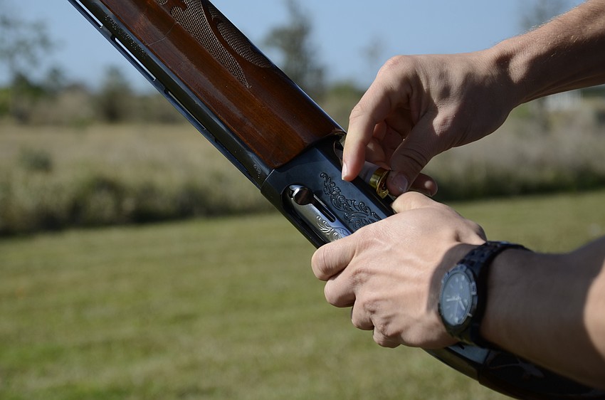 Josh Verlarde loads his shotgun.