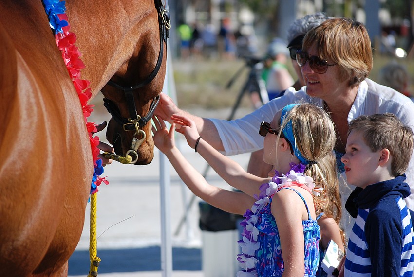 Chloe, Lyla and Roberta Rogers, and Grant Hasbrook pet Charlie, the Sarasota County Sheriff's Office mounted patrol horse