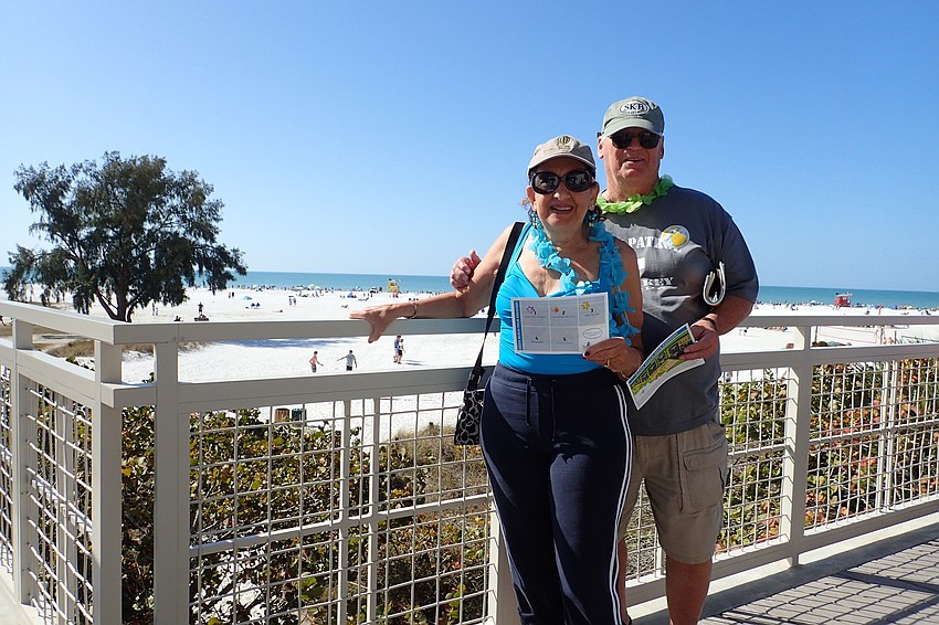 Toni and Ron Sokacz display their passports, part of the opening ceremony activities.