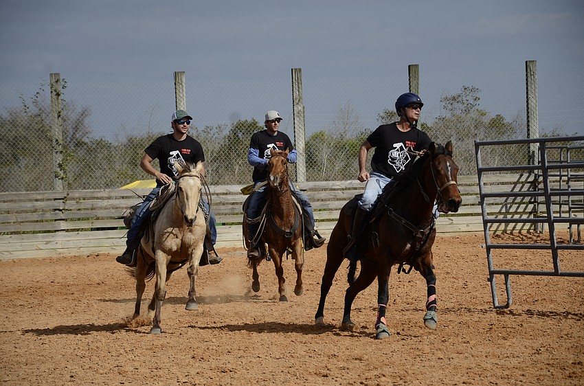 Freddy's Steakburgers team, the event sponsors, ride out for team penning.