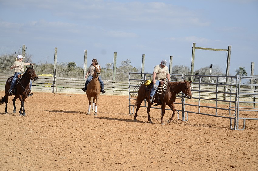 The Polo Grill team rides out for team penning.