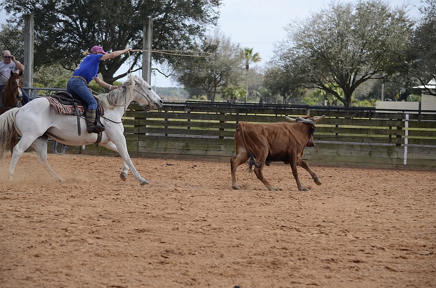 Renée Strickland tosses her lasso at a steer.