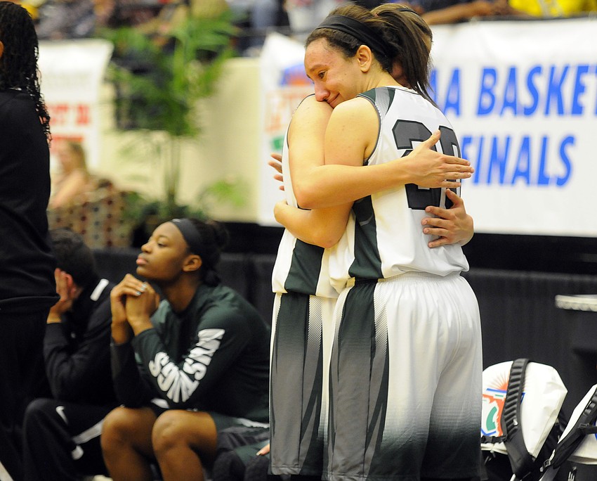 Lakewood Ranch senior Elise Spiller hugs fellow senior Kyra Klarkowski as the final minute ticks off the clock.