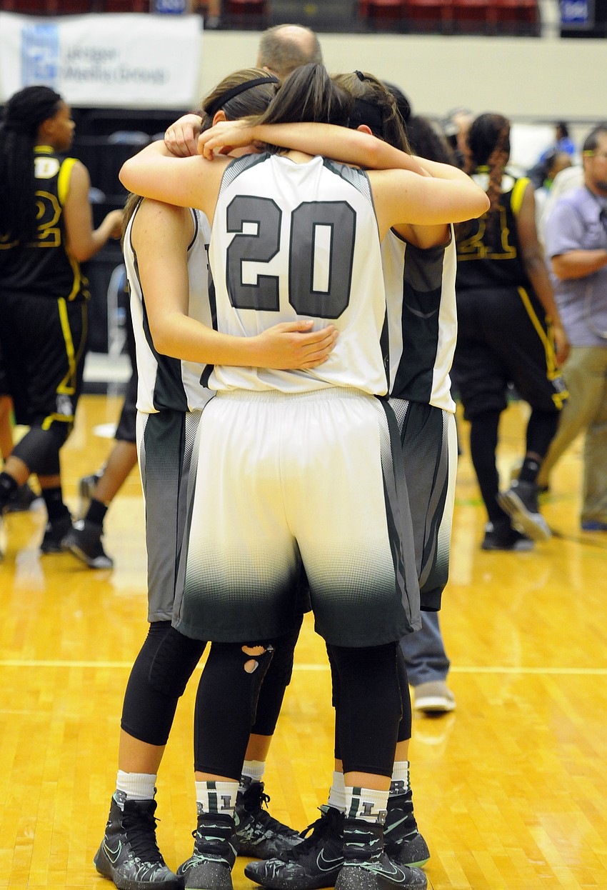 Seniors Kyra Klarkowski, Elise Spiller and Kailyn Scully console one another following the Mustangs loss to Winter Haven.
