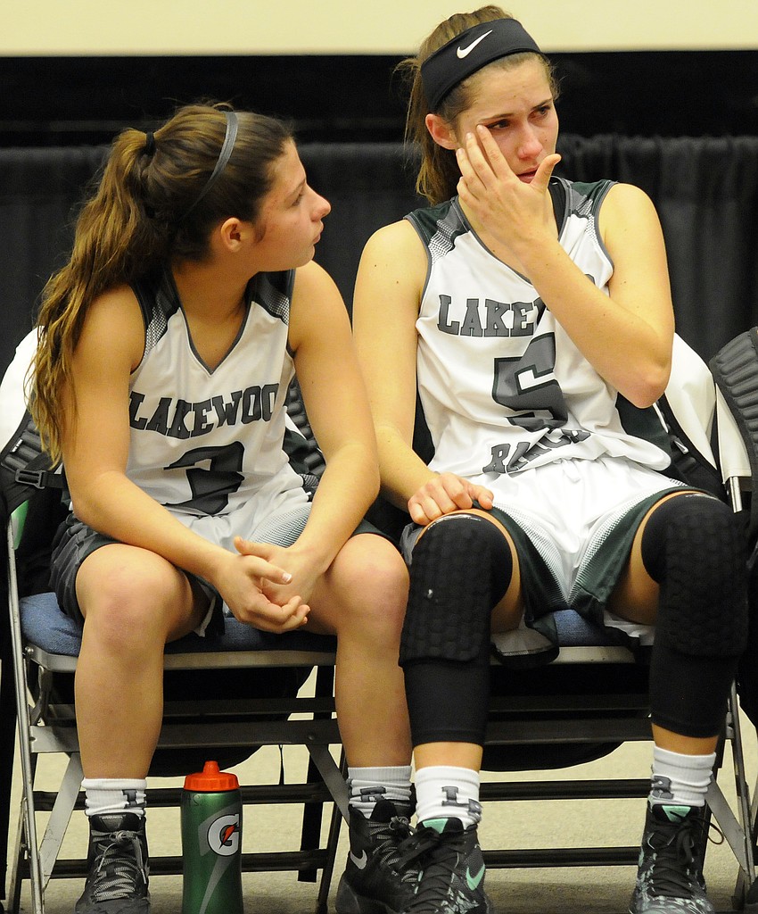 Lakewood Ranch sophomore Emma Fazio sits with senior guard Kailyn Scully following the Mustangs 48-24 loss to Winter Haven in the Class 7A state championship game.