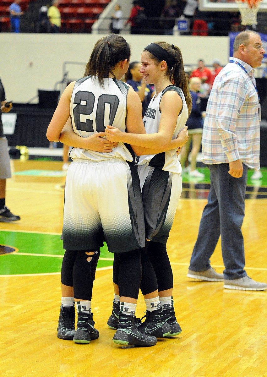 Seniors Kyra Klarkowski, Elise Spiller and Kailyn Scully console one another following the Mustangs loss to Winter Haven.