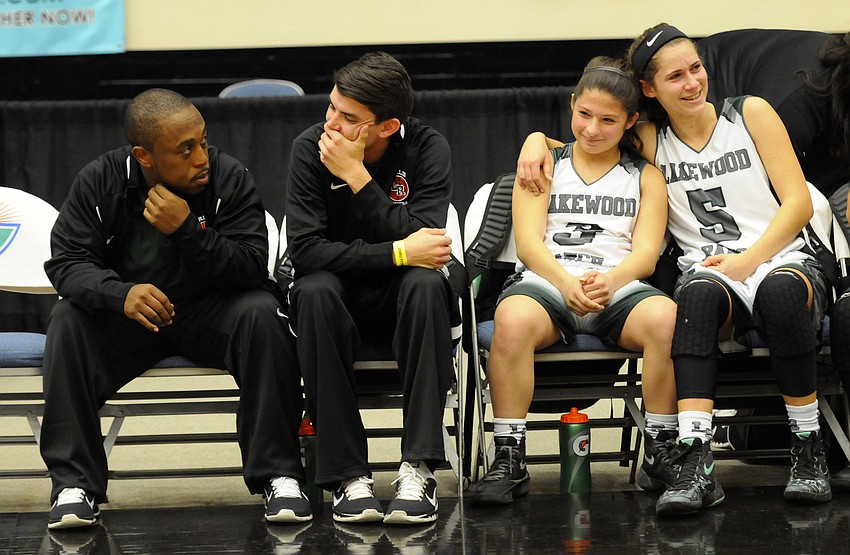 Assistant coaches Frank Bell and Karter Clark and players Emma Fazio and Kailyn Scully wait for the awards ceremony following the Class 7A state championship Feb. 20.