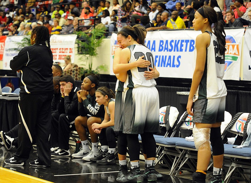 Lakewood Ranch senior Elise Spiller hugs fellow senior Kyra Klarkowski as the final minute ticks off the clock.
