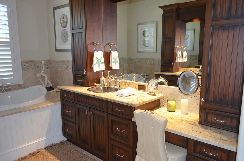 The master bath features his and hers sinks and a vanity.