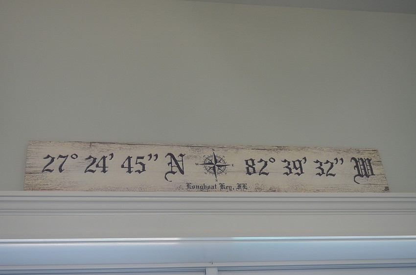 A display of the coordinates of Longboat Key rests above the sliding glass doors to the backyard.