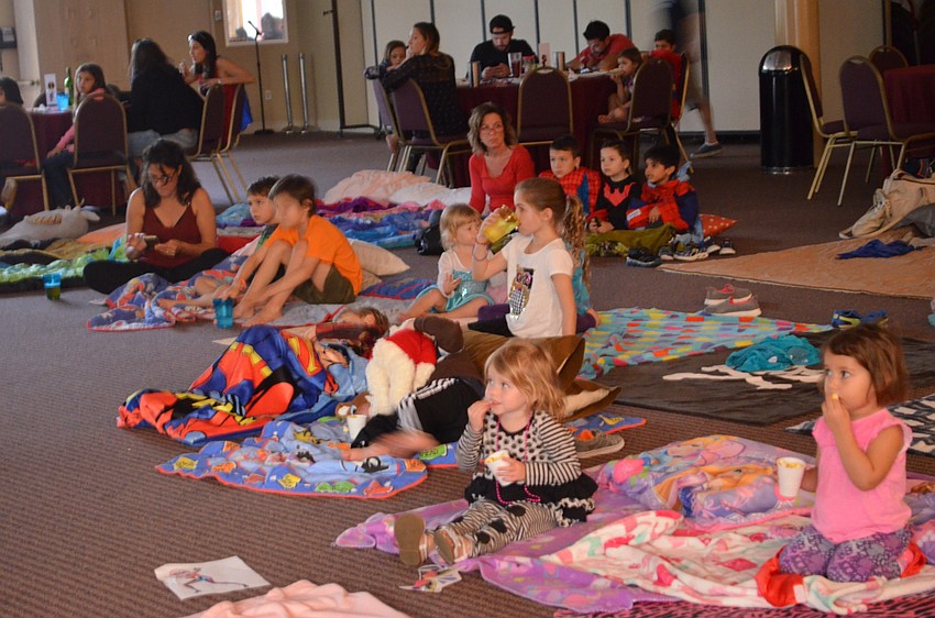 Children and their parents gathered at the start of the featured presentation of Disney's 