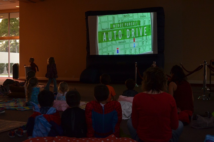 Children and their parents gathered at the start of the featured presentation of Disney's 