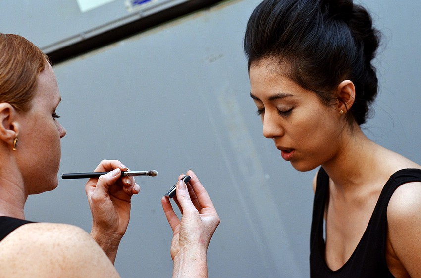 Models get ready for the show backstage at Saks.