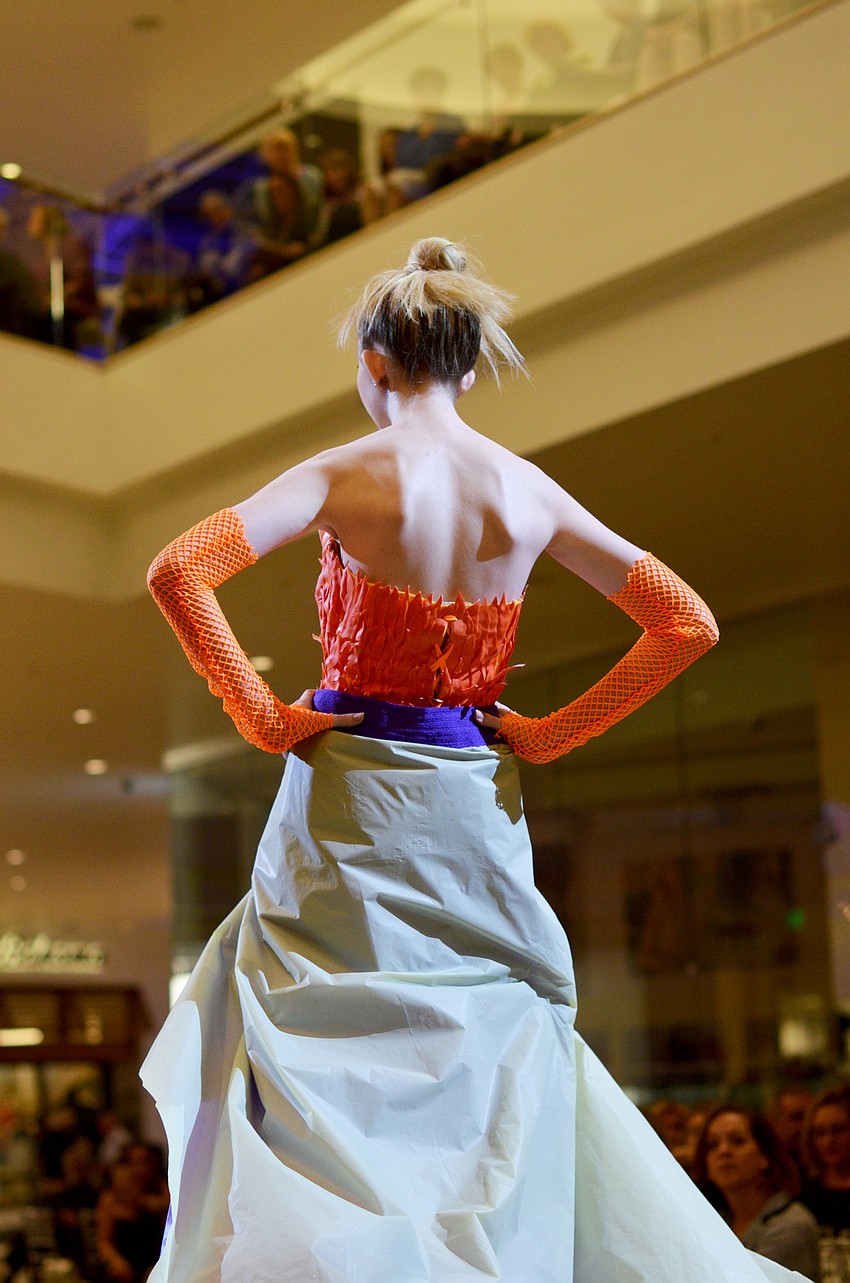 Brenna Maginess models Susan Burke's 'Bird of Paradise' — made from rubber gloves, plastic table cloths and mesh bags