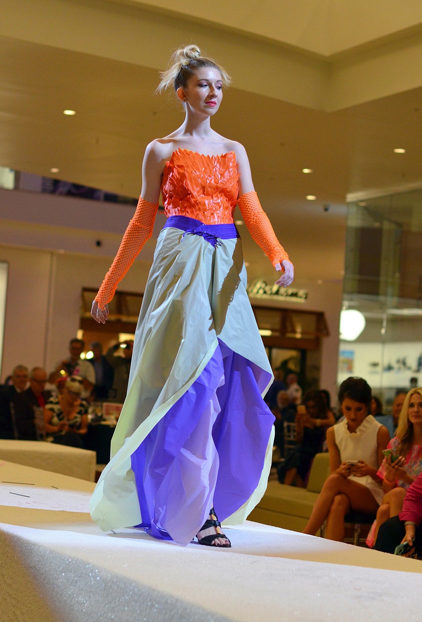 Brenna Maginess models Susan Burke's 'Bird of Paradise' — made from rubber gloves, plastic table cloths and mesh bags