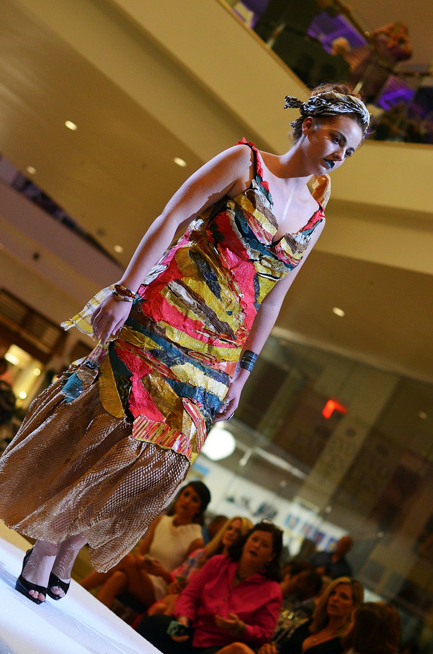 Ali Lambert models Ali Lambert's 'Paper or Plastic' — made from paper, paint and acrylic mediums